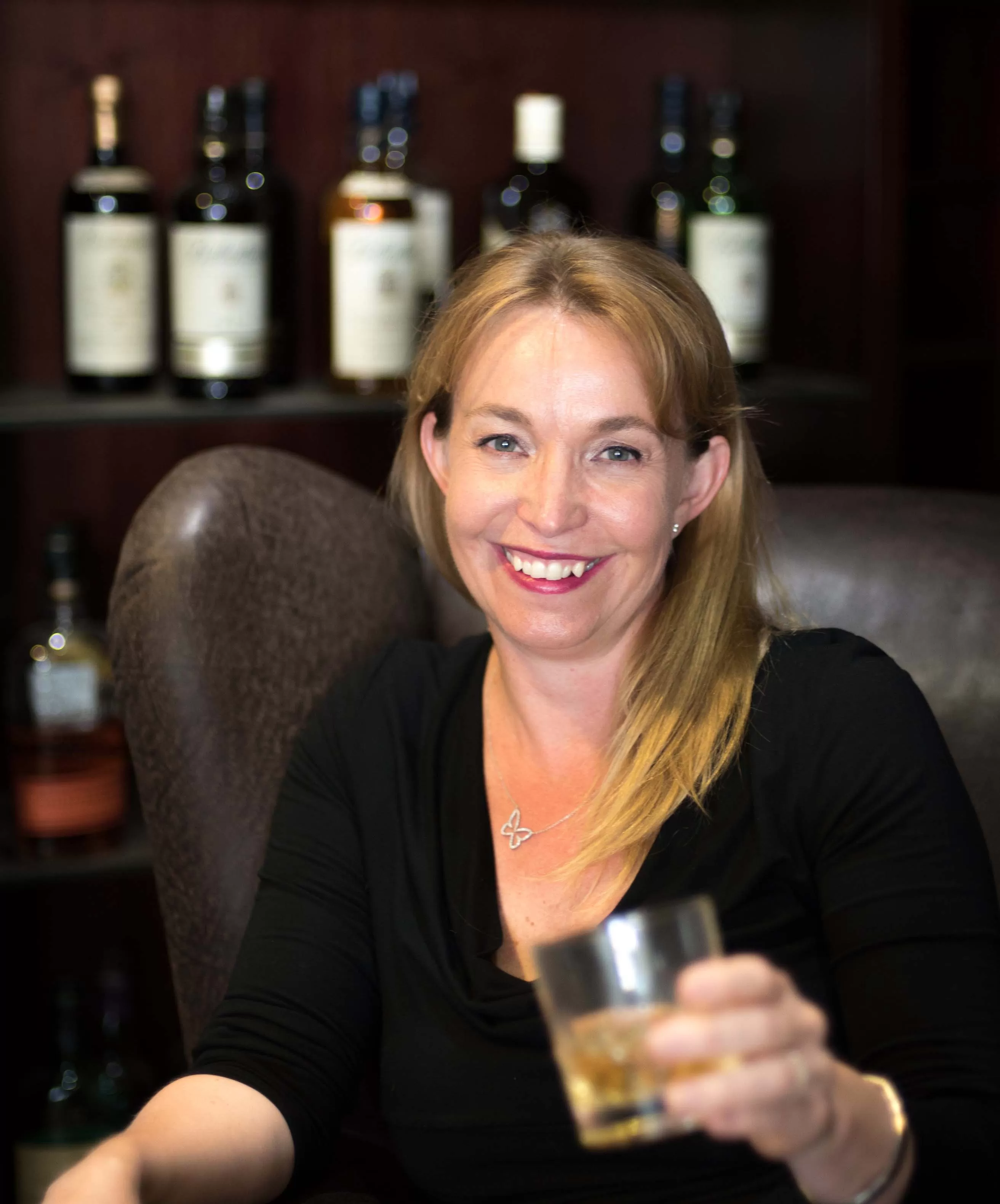 Jeannette Wentzel sitting in the whisky room About Me Whisky of the Week