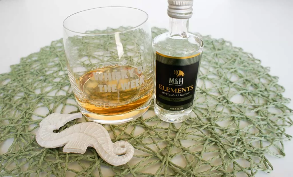 Milk & Honey Elements peated whisky with glass
