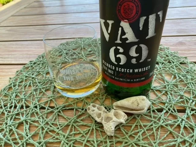 bottle of VAT 69 whisky with glass