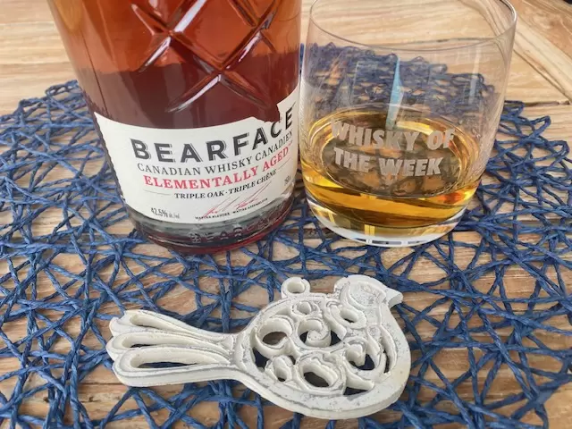 bearface triple oak whisky with glass